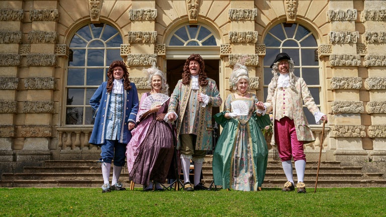Costumed Characters in 18th century dress stand in front of the Banqueting House at Fountains Abbey and Studley Royal